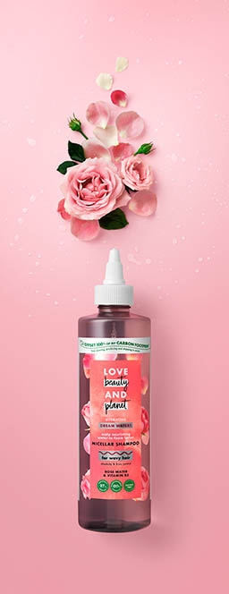 Coloured background Explorer of Love Beauty and Planet hair care shampoo with ingredients