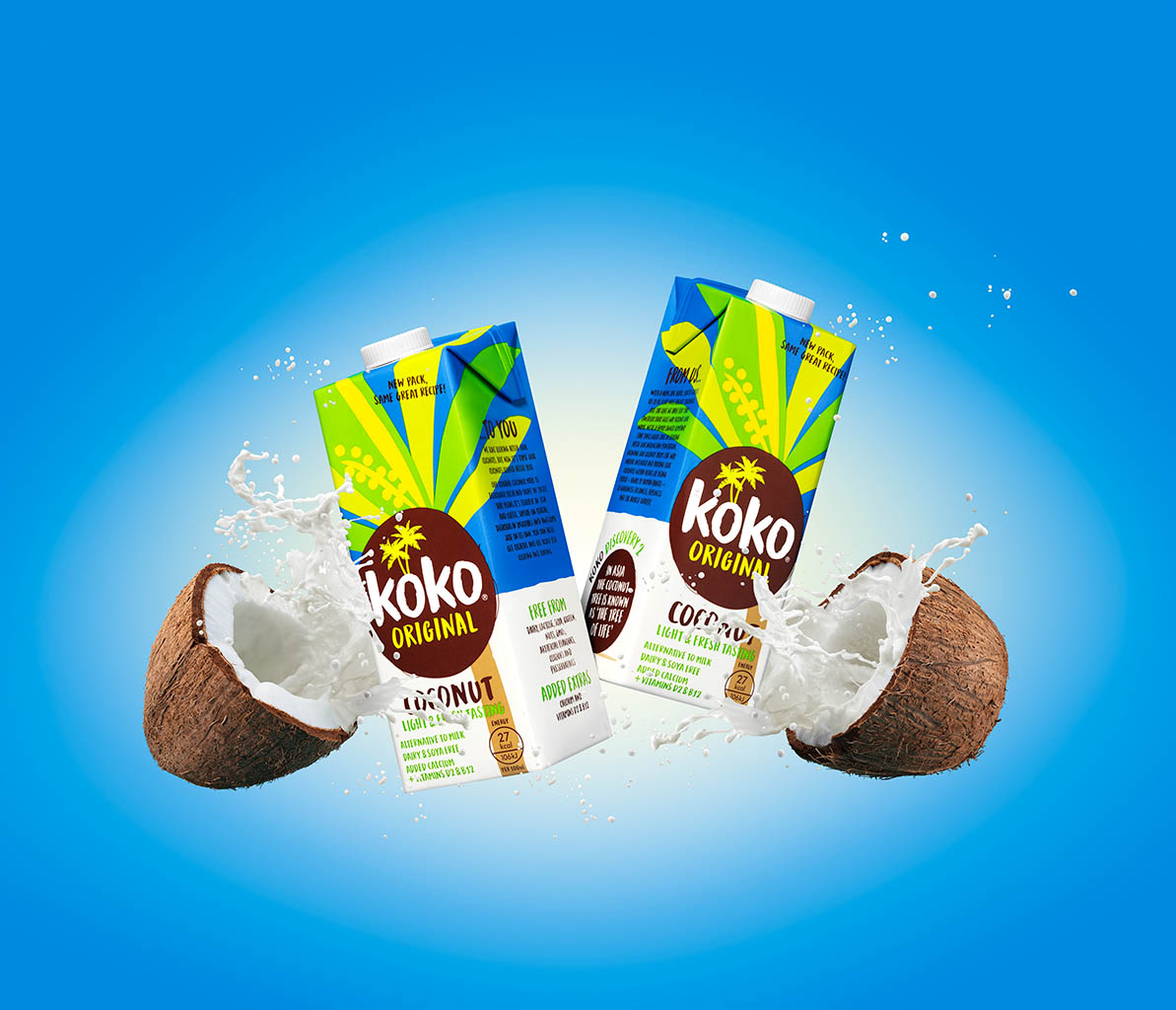 Creative Still Life Product Photography and Retouching of Koko milk cartons with smashing coconuts and milk splash by Packshot Factory