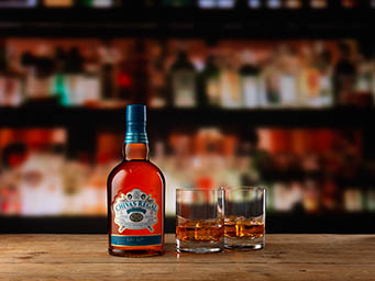Coloured background Explorer of Chivas Regal whisky bottle and serve